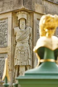 Statue of buddha against building