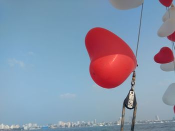 Low angle view of balloons against blue sky