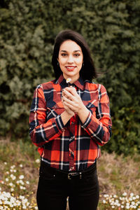 Portrait of beautiful woman while standing outdoors