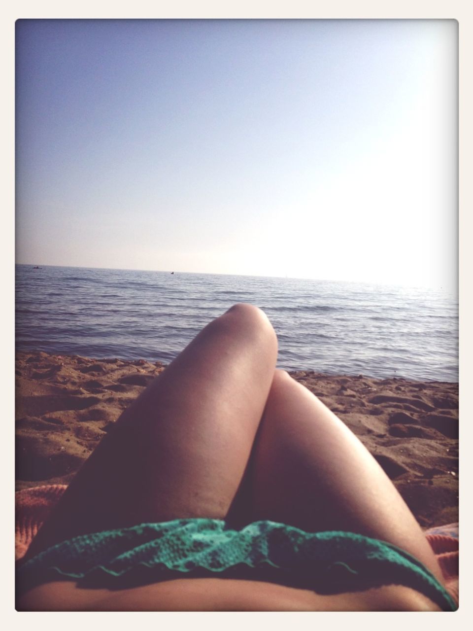 sea, horizon over water, transfer print, person, low section, auto post production filter, water, personal perspective, clear sky, beach, relaxation, copy space, lifestyles, barefoot, leisure activity, vacations