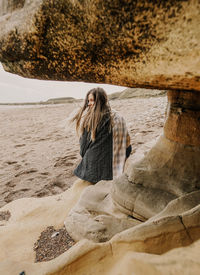 Woman sitting on rock