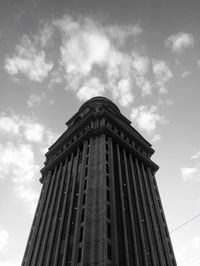 Low angle view of tower against cloudy sky