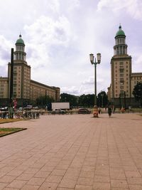 Buildings against cloudy sky