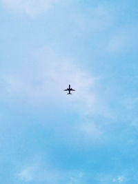 Low angle view of airplane flying in sky