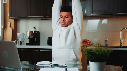 Portrait of young woman exercising at home