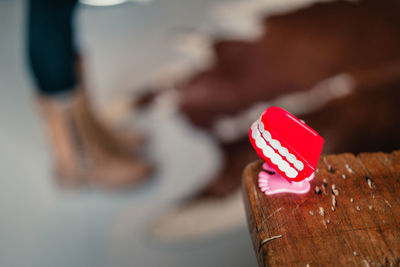 Close-up of hand on red surface