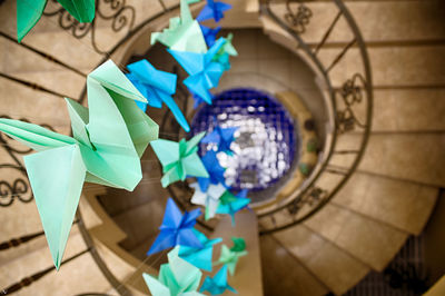 High angle view of paper cranes hanging over steps