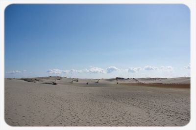 Scenic view of landscape against blue sky