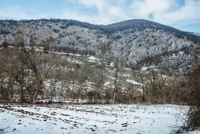 Scenic view of snow covered mountains against sky