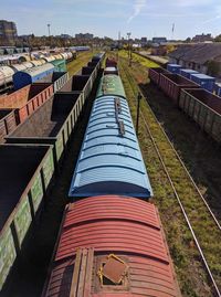 High angle view of railroad tracks amidst field against sky