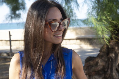 Portrait of young woman wearing sunglasses