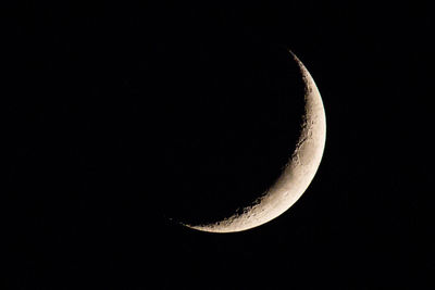 Low angle view of half moon against sky at night