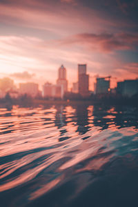 Scenic view of buildings against sky during sunset