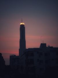 Low angle view of silhouette buildings against sky during sunset