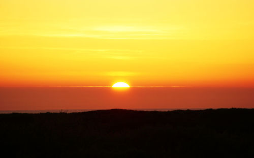 Scenic view of silhouette landscape against romantic sky at sunset