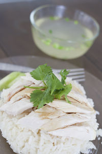 Close-up of rice with chicken in plate on table