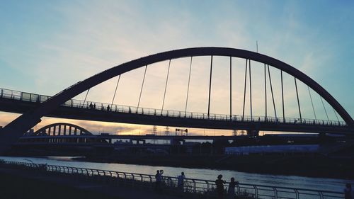 View of suspension bridge against cloudy sky