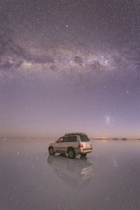 Cars on car against sky at night