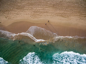 Directly above shot of people walking at beach