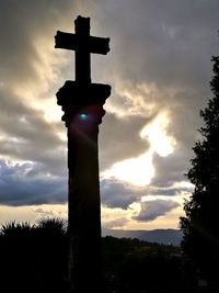 Low angle view of silhouette statue against sky during sunset