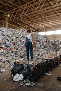 Full length of a man standing by garbage