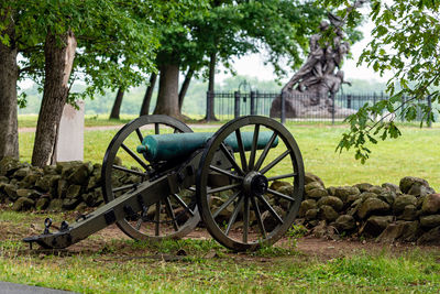 Bicycle on field against trees