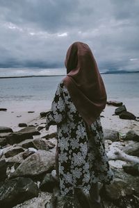 Man looking at sea against sky