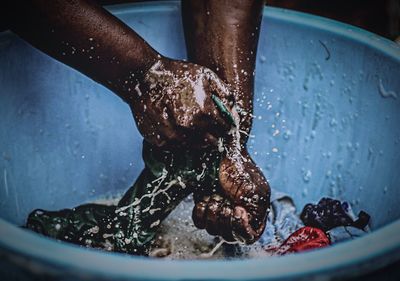 Close-up of man hand in water