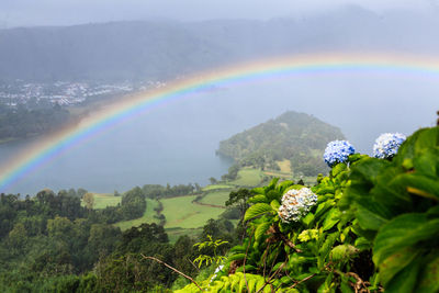 Scenic view of rainbow over mountains