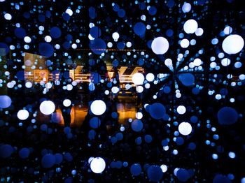 Defocused image of illuminated street lights at night