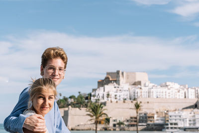 Portrait of happy friends against sky