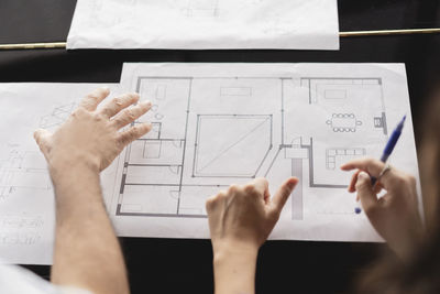 Colleagues reviewing business plan on table at office