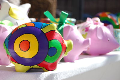 Close-up of colorful piggy banks on table