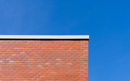 Low angle view of building against clear blue sky