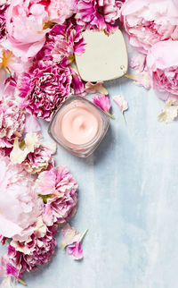 Handcream with roses on textured surface