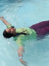 High angle view of woman swimming in pool
