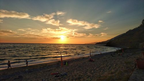 Scenic view of beach against sky during sunset
