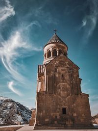 Low angle view of church against blue sky during sunny day