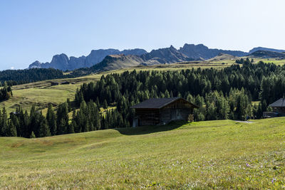 Scenic view of green landscape and mountains against sky