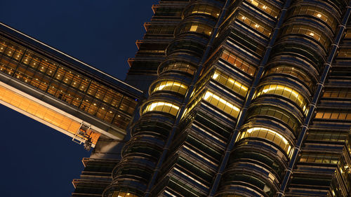 Low angle view of illuminated building against sky at night