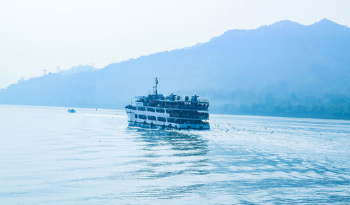 Ship sailing in sea against sky