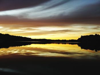 Scenic view of lake against orange sky