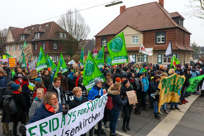 Group of people on street against buildings in city