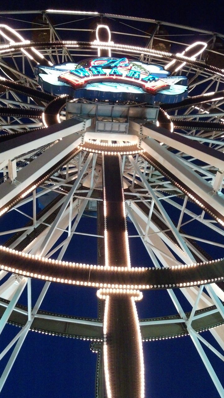 low angle view, illuminated, built structure, architecture, night, ceiling, blue, amusement park ride, indoors, arts culture and entertainment, amusement park, metal, modern, famous place, architectural feature, travel, travel destinations, pattern, ferris wheel, lighting equipment