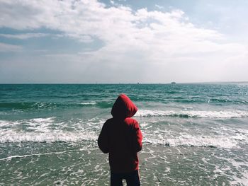 Rear view of woman standing on beach