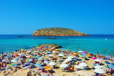 Scenic view of beach against clear blue sky