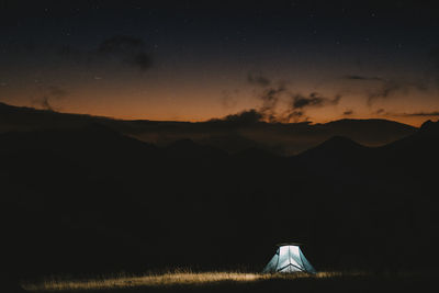 Scenic view of mountains against sky at night