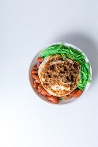 Directly above shot of food over white background