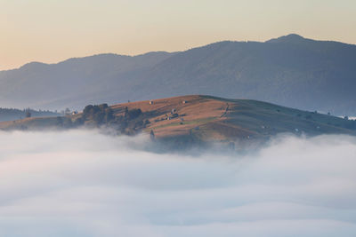 Scenic view of mountains against clear sky during sunset