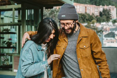 Young couple standing outdoors